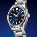 Grand Seiko SLGH003 blue dial stainless steel wristwatch against blue background. 