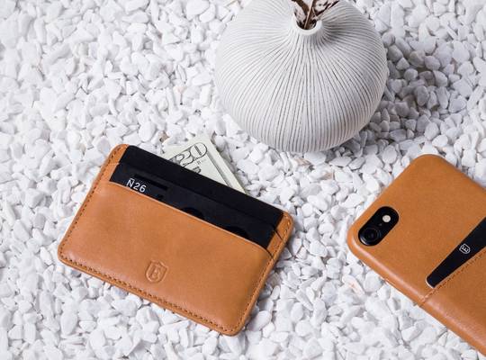 Ekster premium leather cardholder alongside iPhone in leather case
