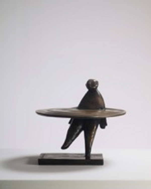 bronze sculpture of a man in a ring