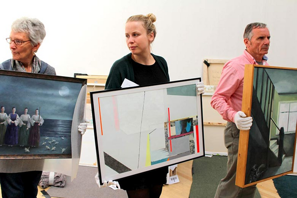 volunteers carry artworks during RWA selection day