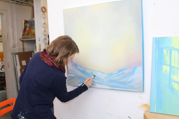 photo of jemma grundon painting in her studio