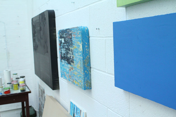 photo of some of Stewart Geddes' paintings on the wall 