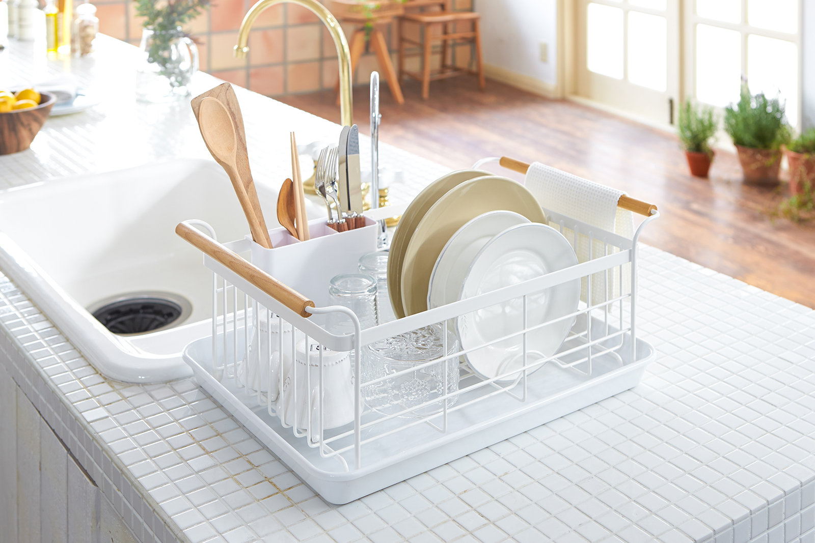 Yamazaki Home Tosca Dish Rack holding plates and utensils on a kitchen counter. 