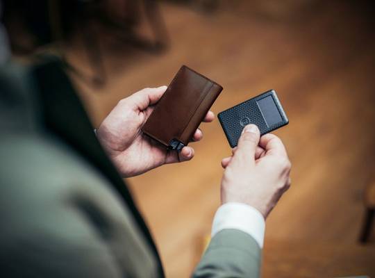 Person holding Italian Leather Parliament 
wallet with tracker card 