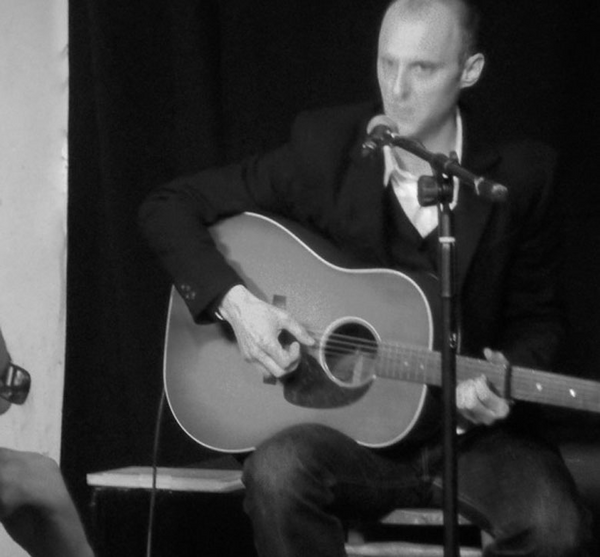 photo of Joel Edwards playing guitar