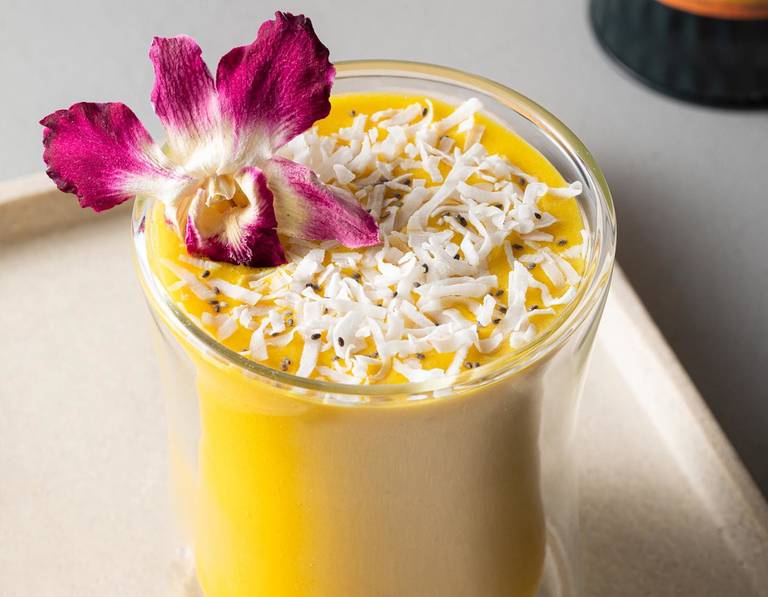 Tropical Tantra Chai Smoothie in a POOM glass with a orchid garnish