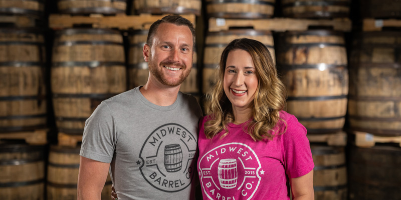 Ben & Jess Loseke, Midwest Barrel Co. Co-Owners, in warehouse full of whiskey barrels
