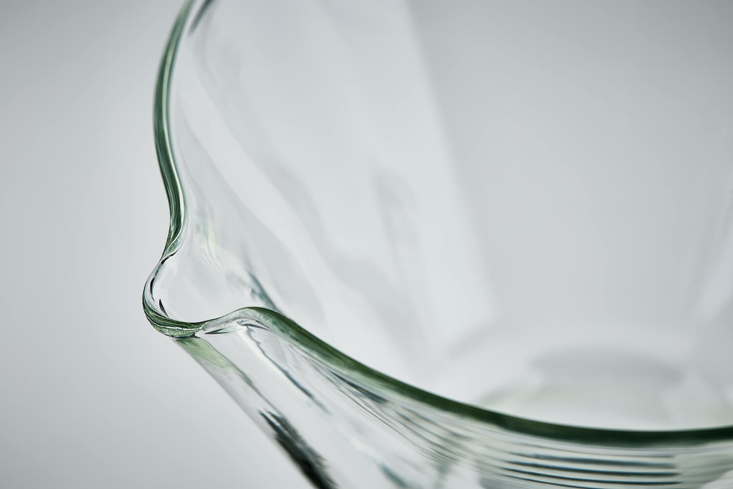 Up close view of the glass carafe pour spout. 