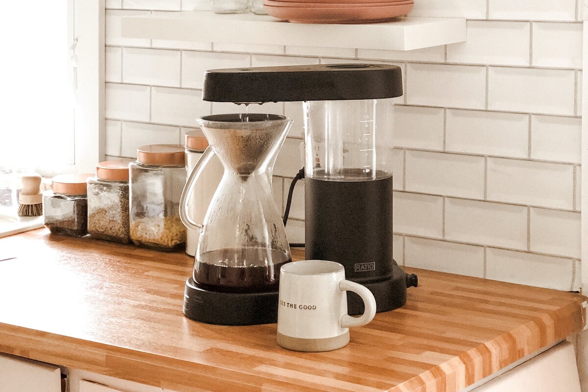 The glass carafe and Kone being used to brew coffee. 