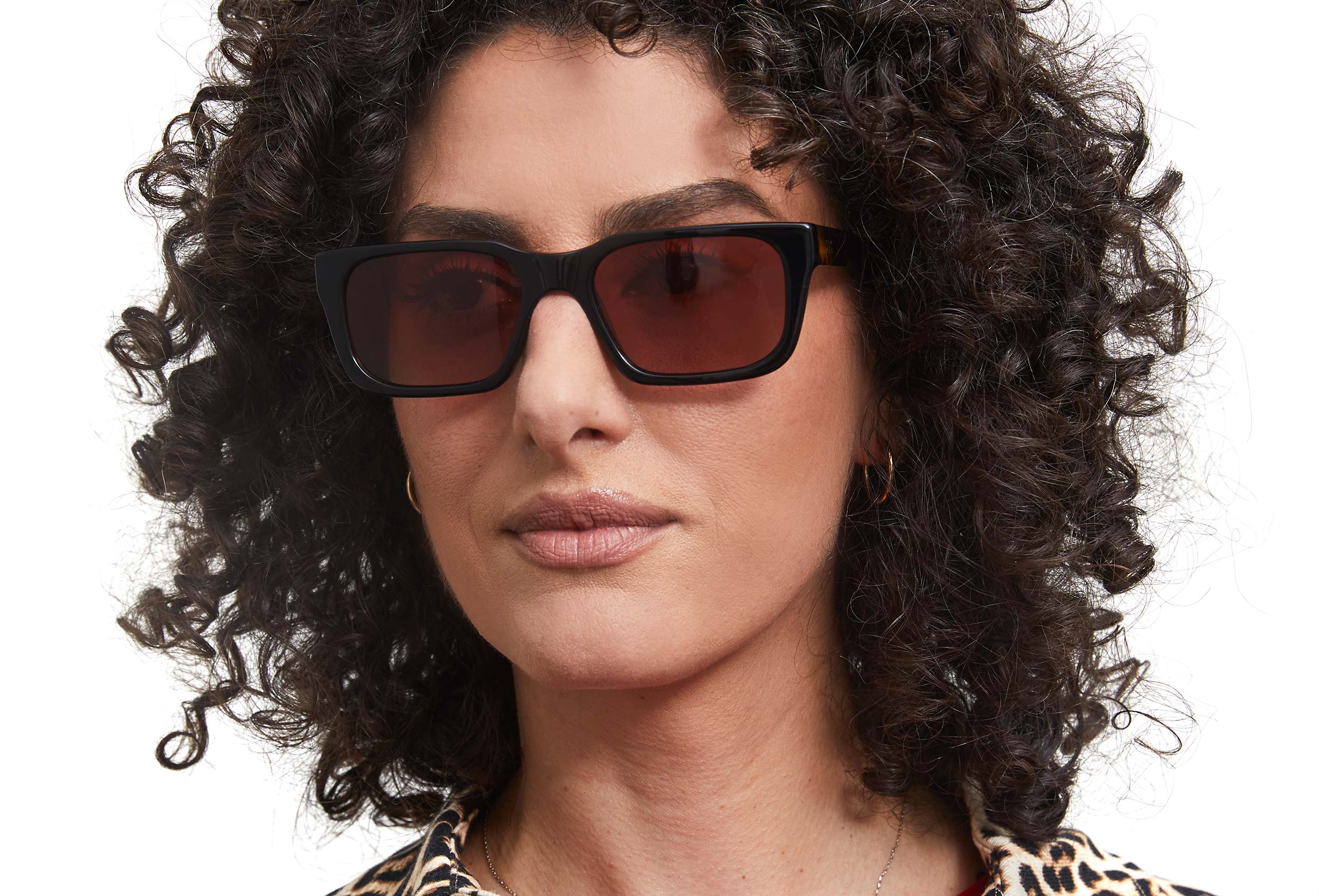 Photo of a man or woman wearing Victoire Sun Cognac Sun Glasses by French Kiwis