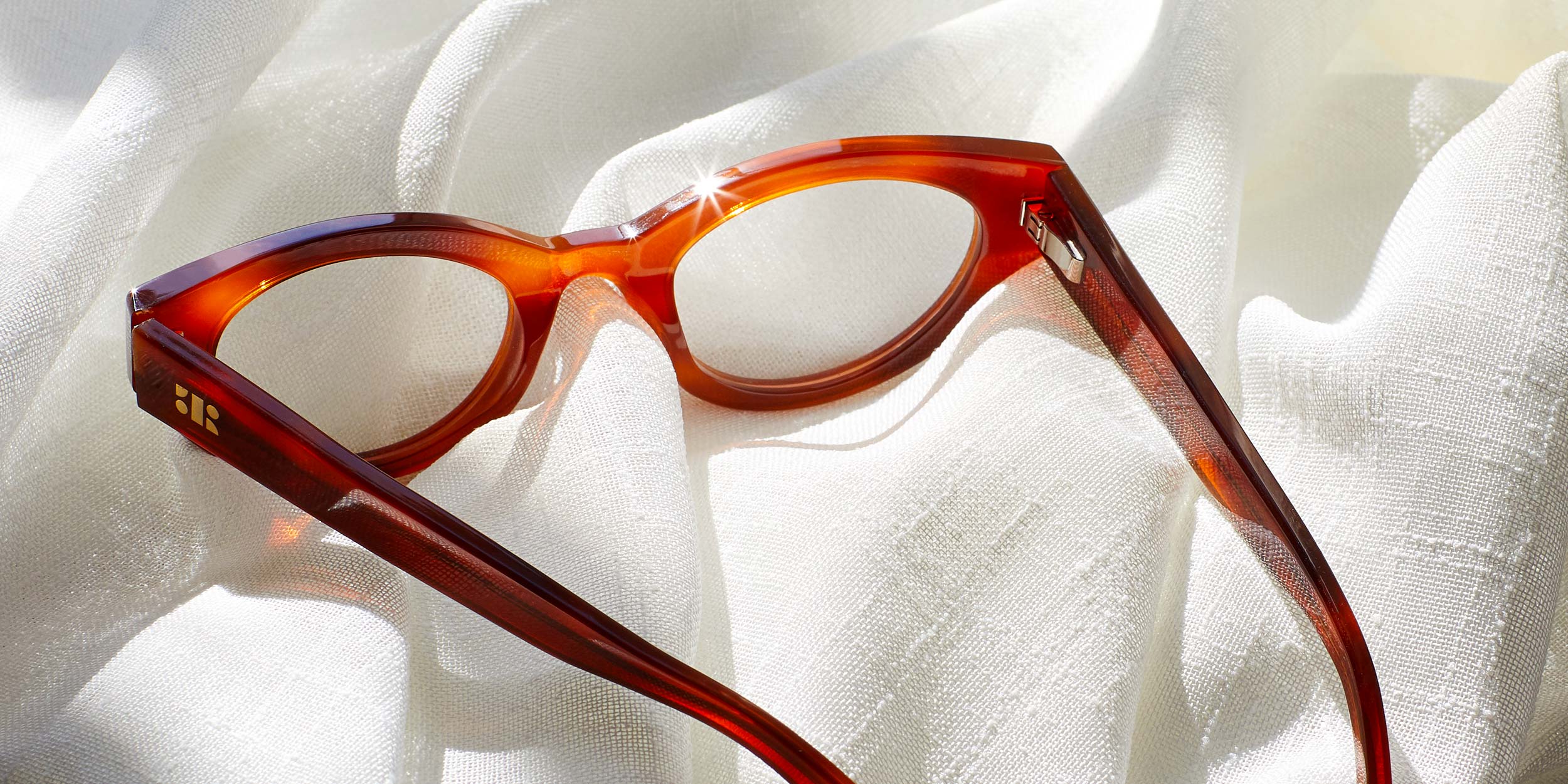 Photo Details of Camille Clear Tan & Grey Marble Reading Glasses in a room