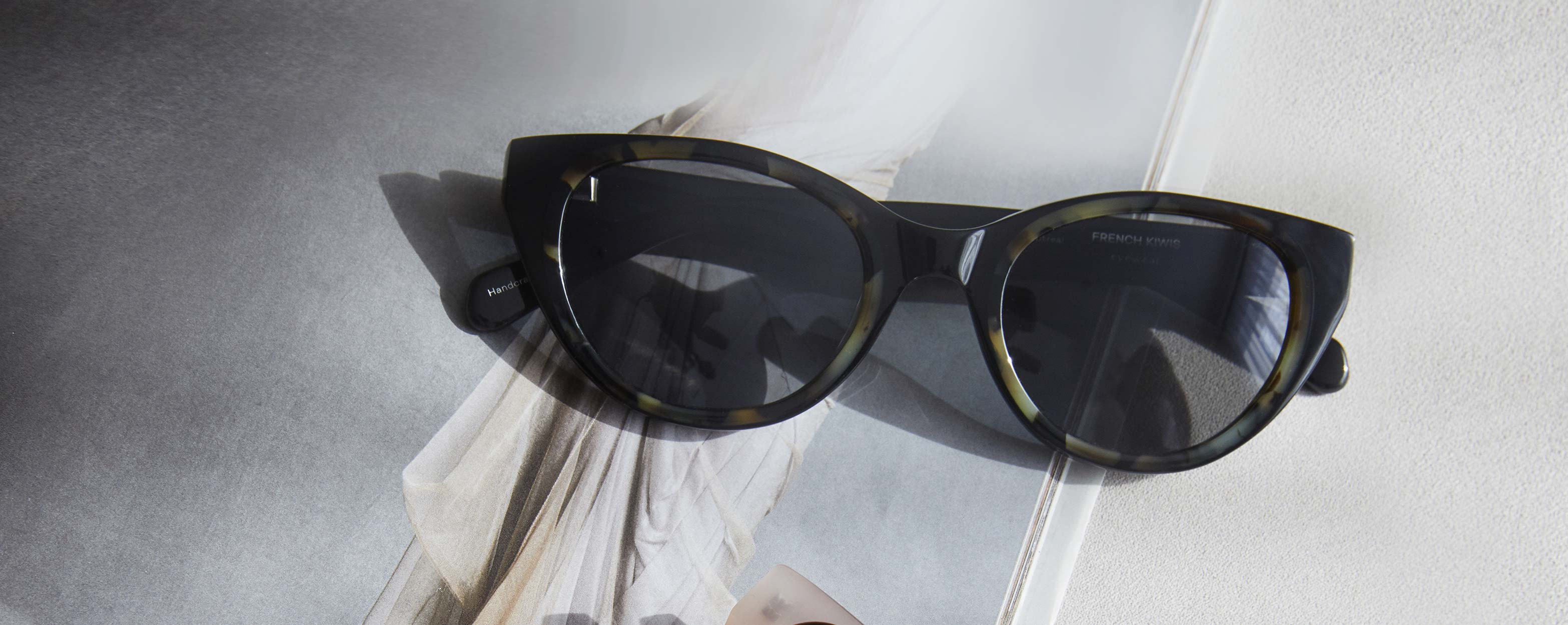 Photo Details of Colette Sun Clear Taupe & Grey Marble Sun Glasses in a room