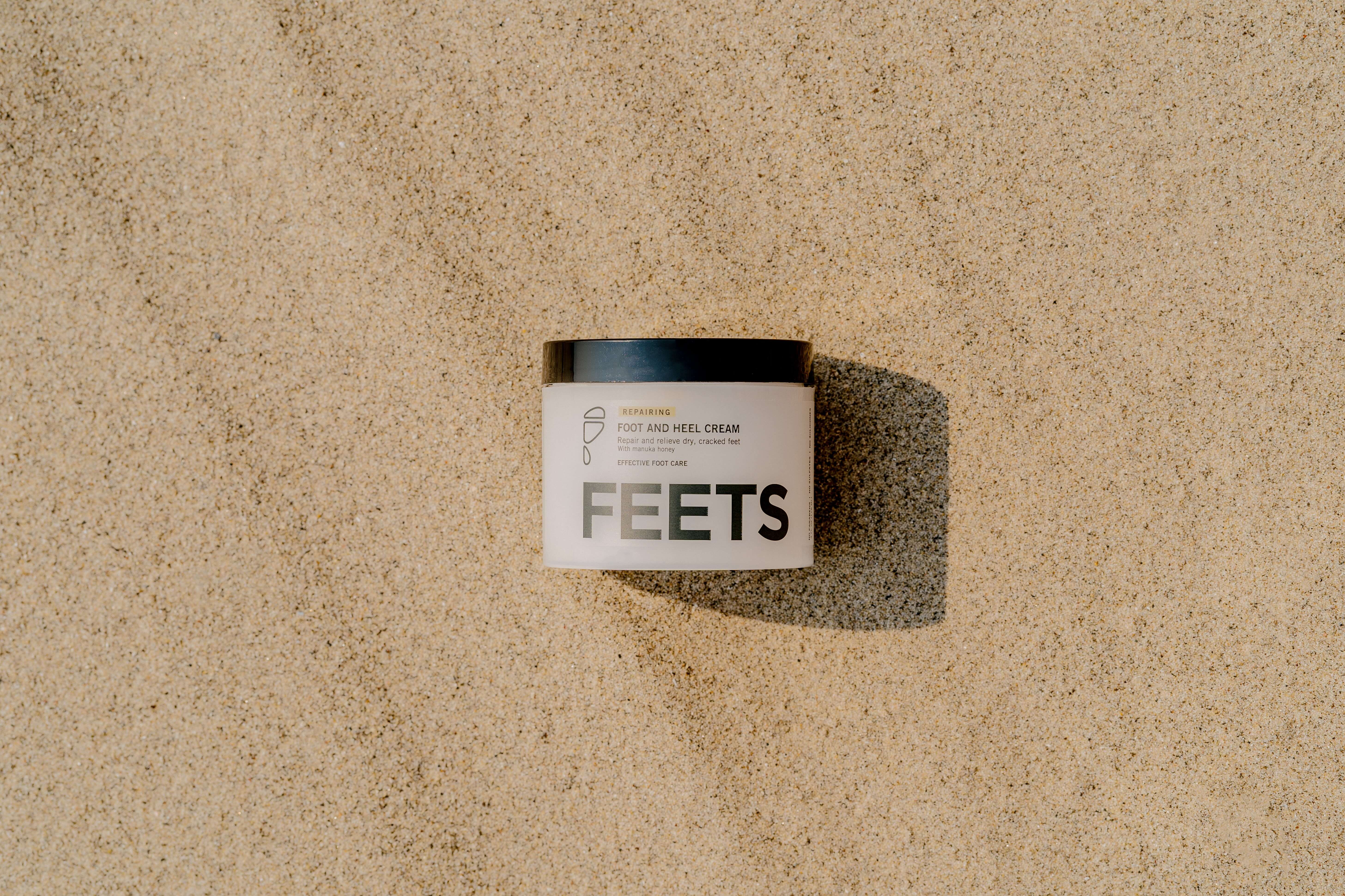 Foot and heal cream on beach