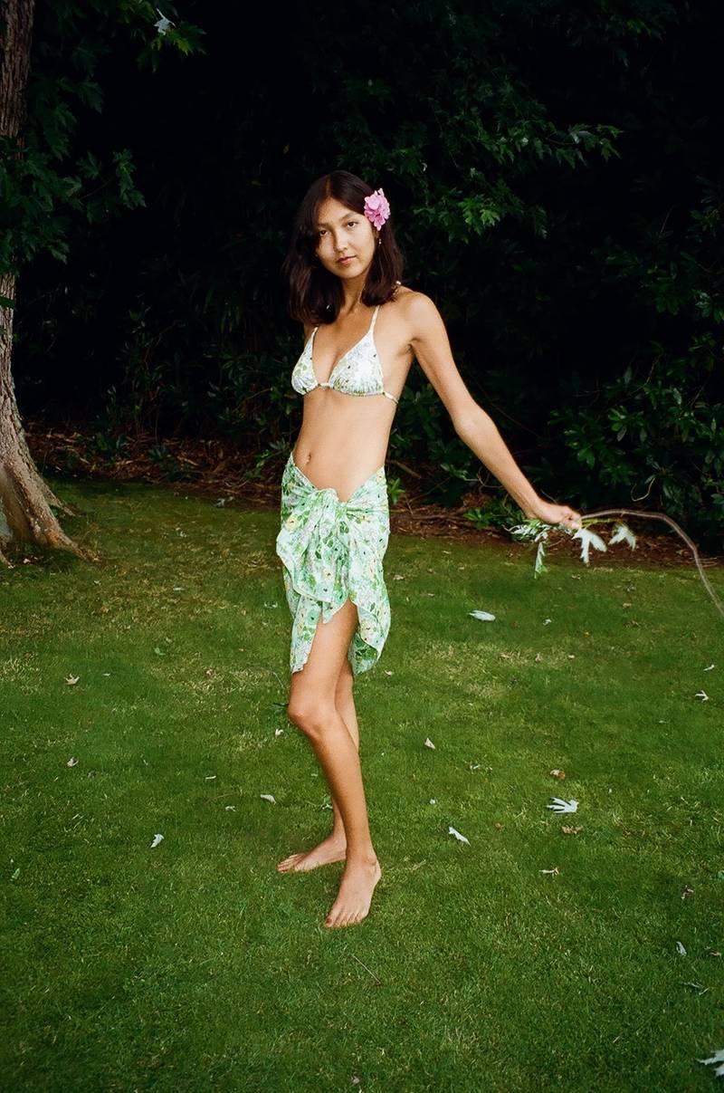 Bernadette Antwerp triangle tie bikini made from recycled materials, adorned with green daisies.