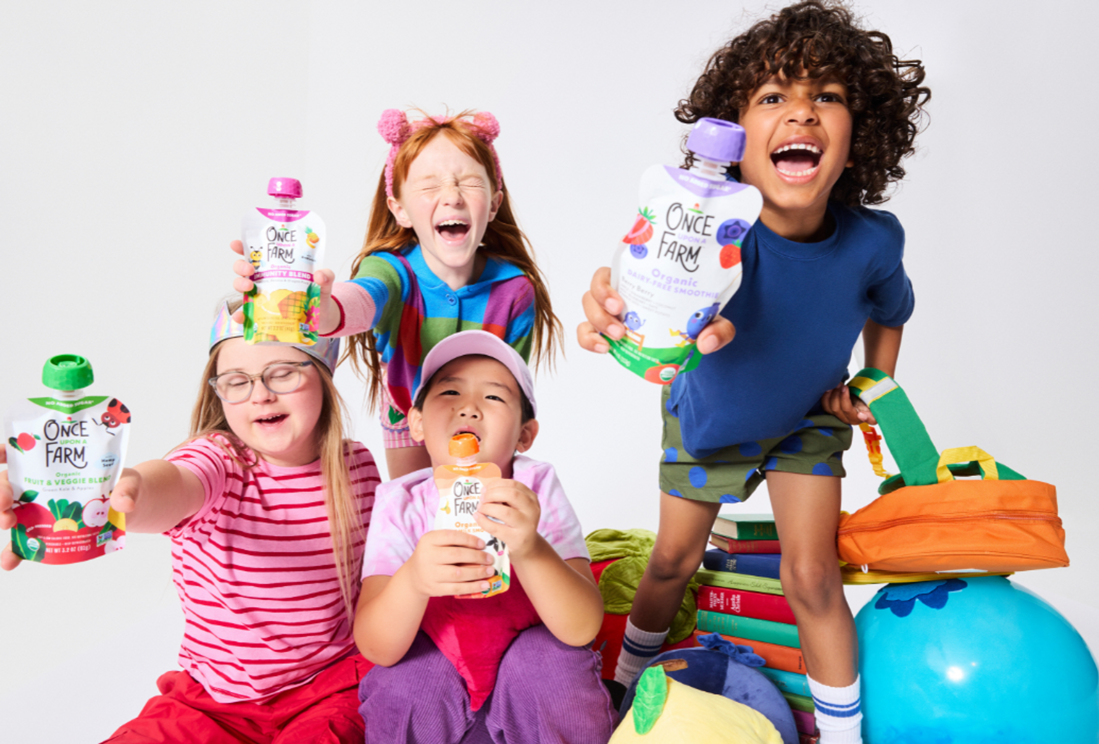 photography of kids holding Once Upon a Farm Pouches