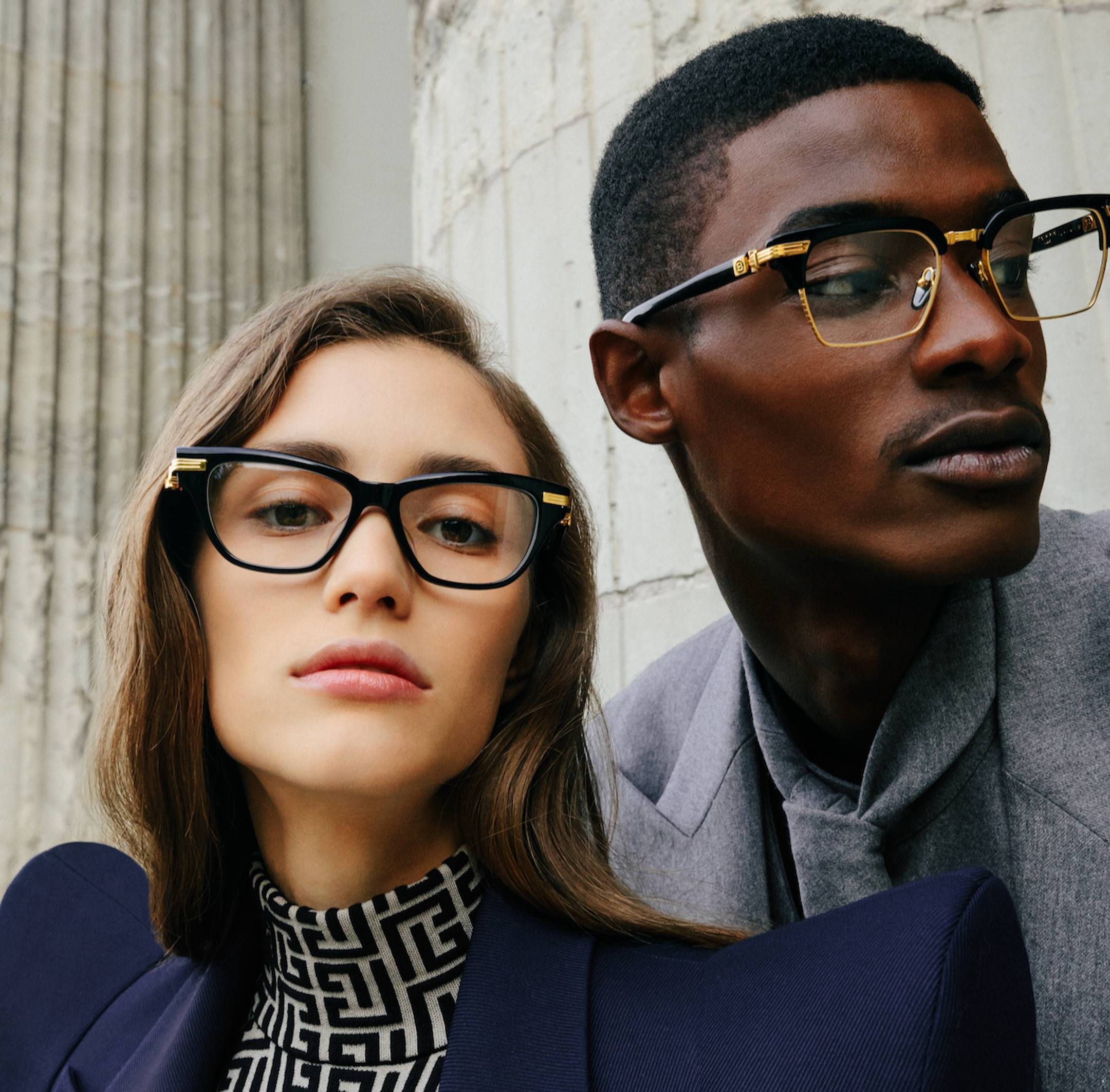 Male and female models wearing Balmain eyeglasses