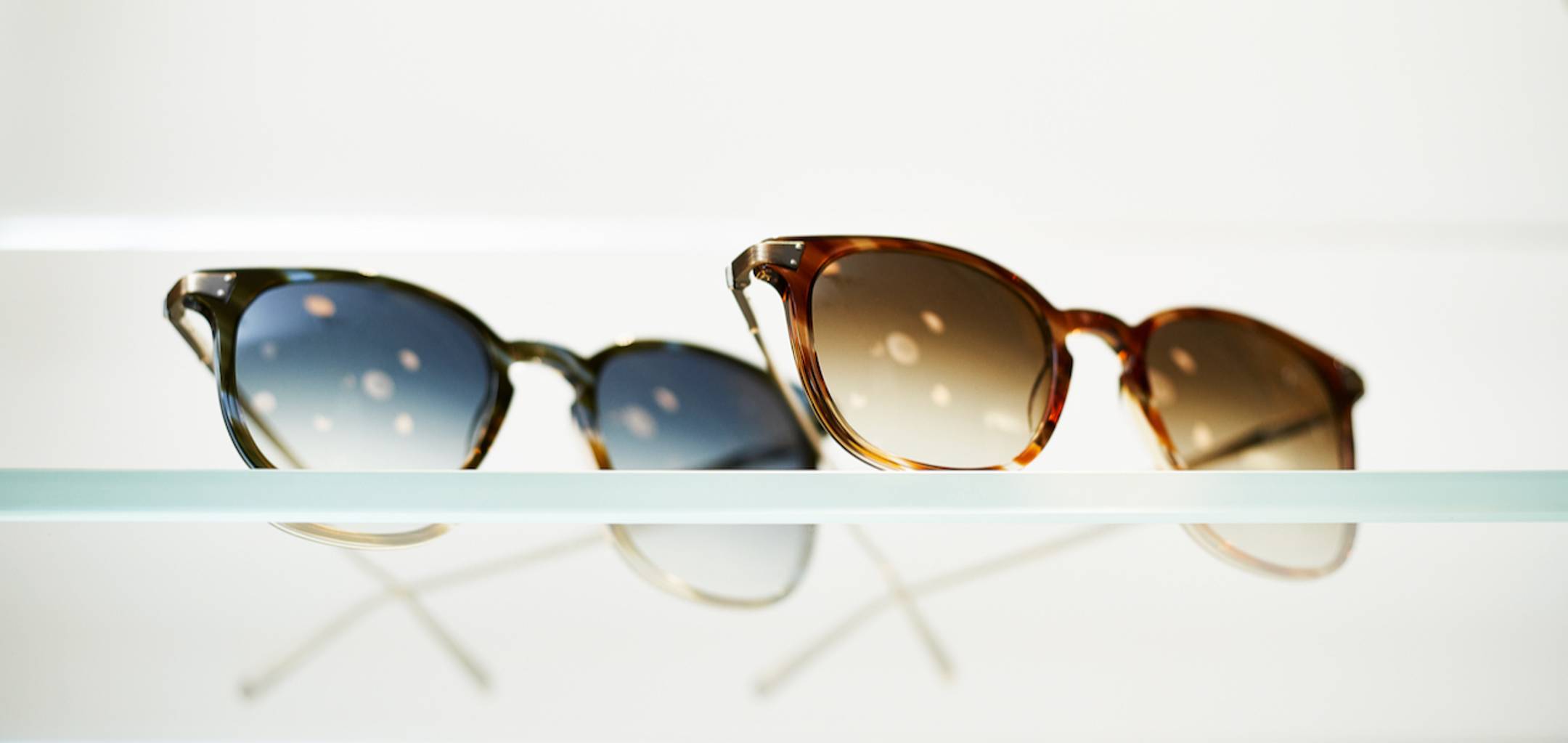 Close up shot of two pairs of sunglasses