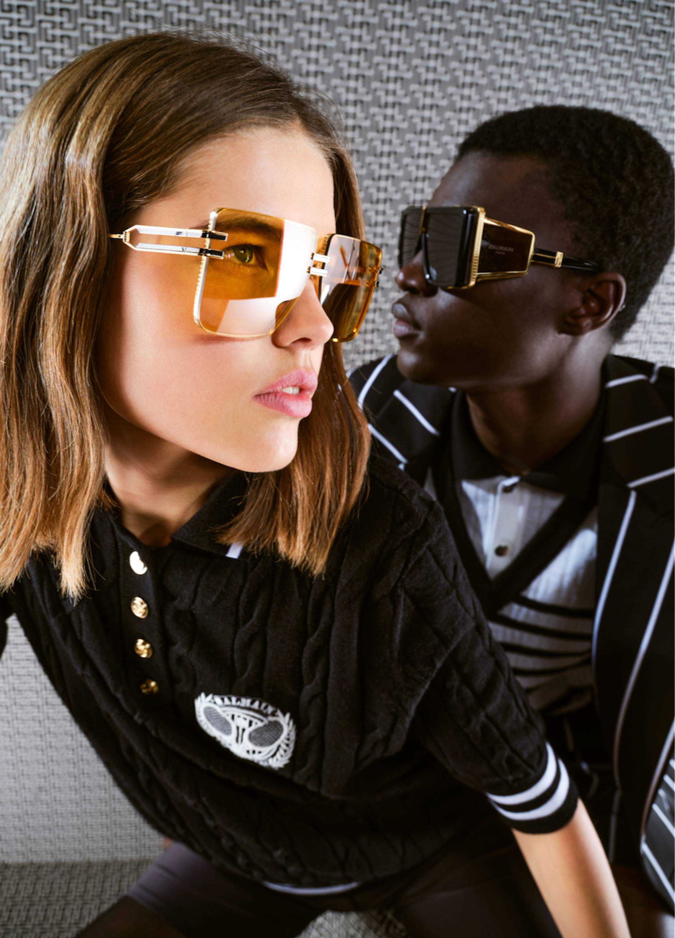 Male and female models wearing Balmain sunglasses