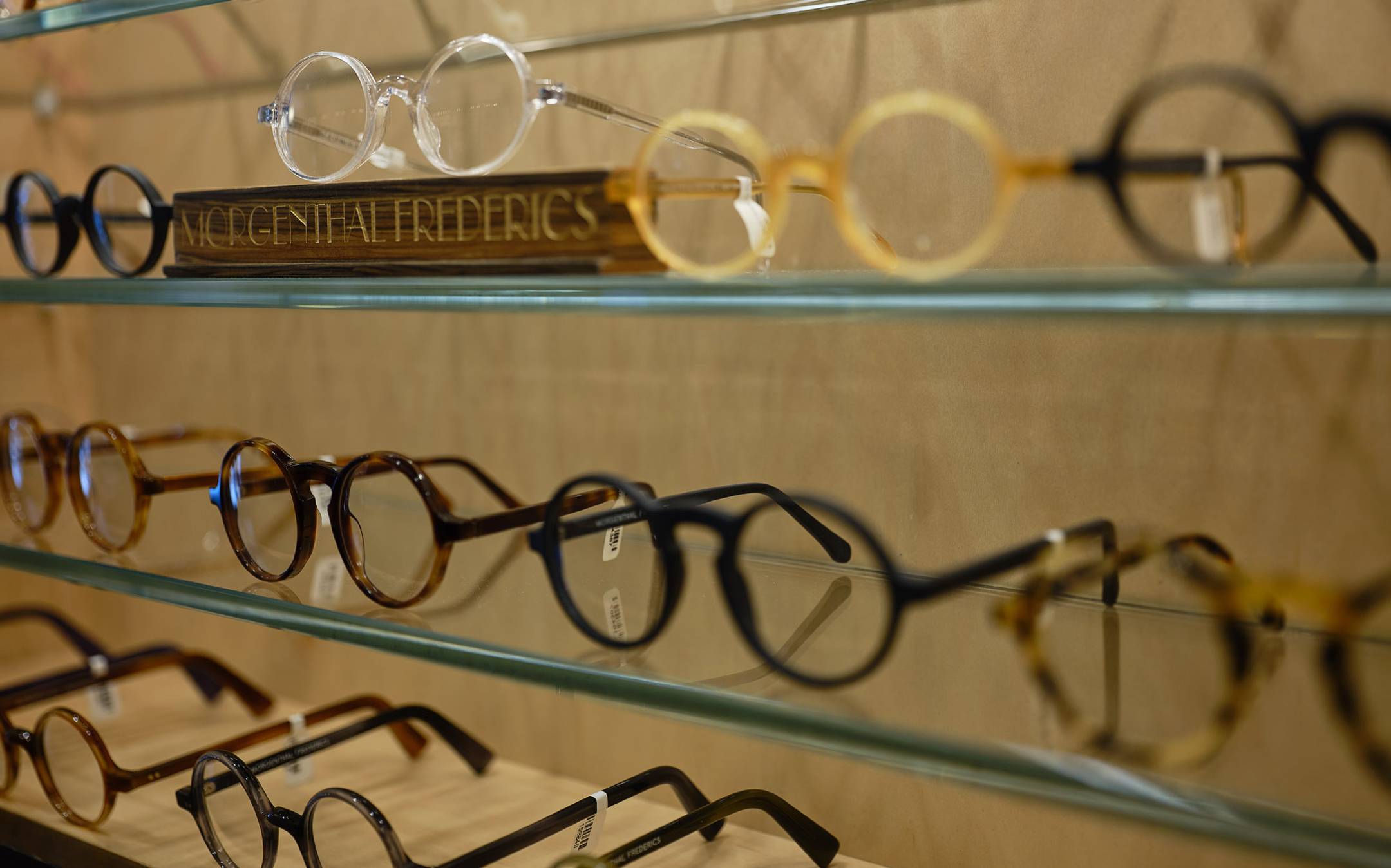 Close up of multiple pairs of Morgenthal Frederics eyeglasses on a shelf