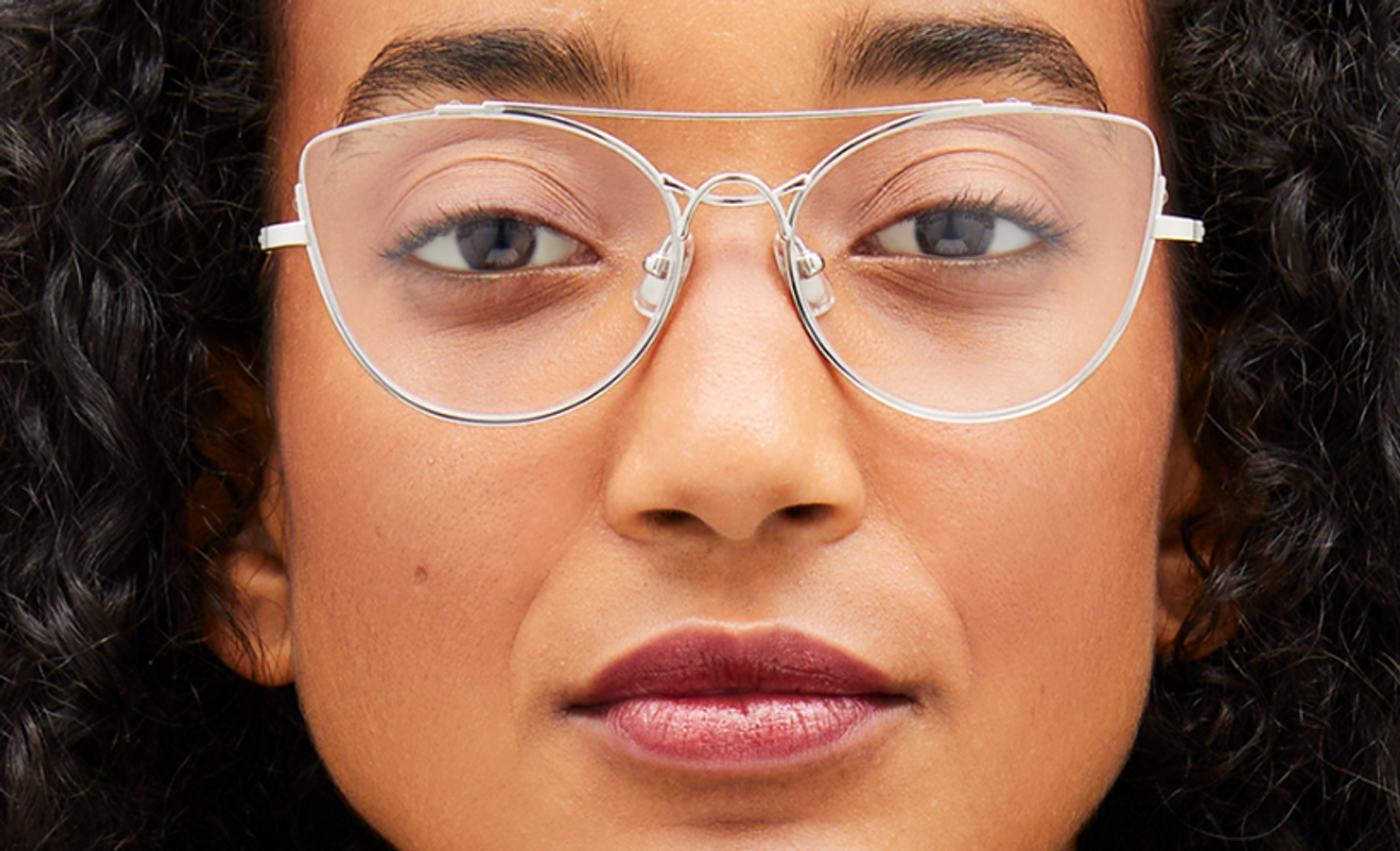 Close-up of a female model wearing metal designer glasses