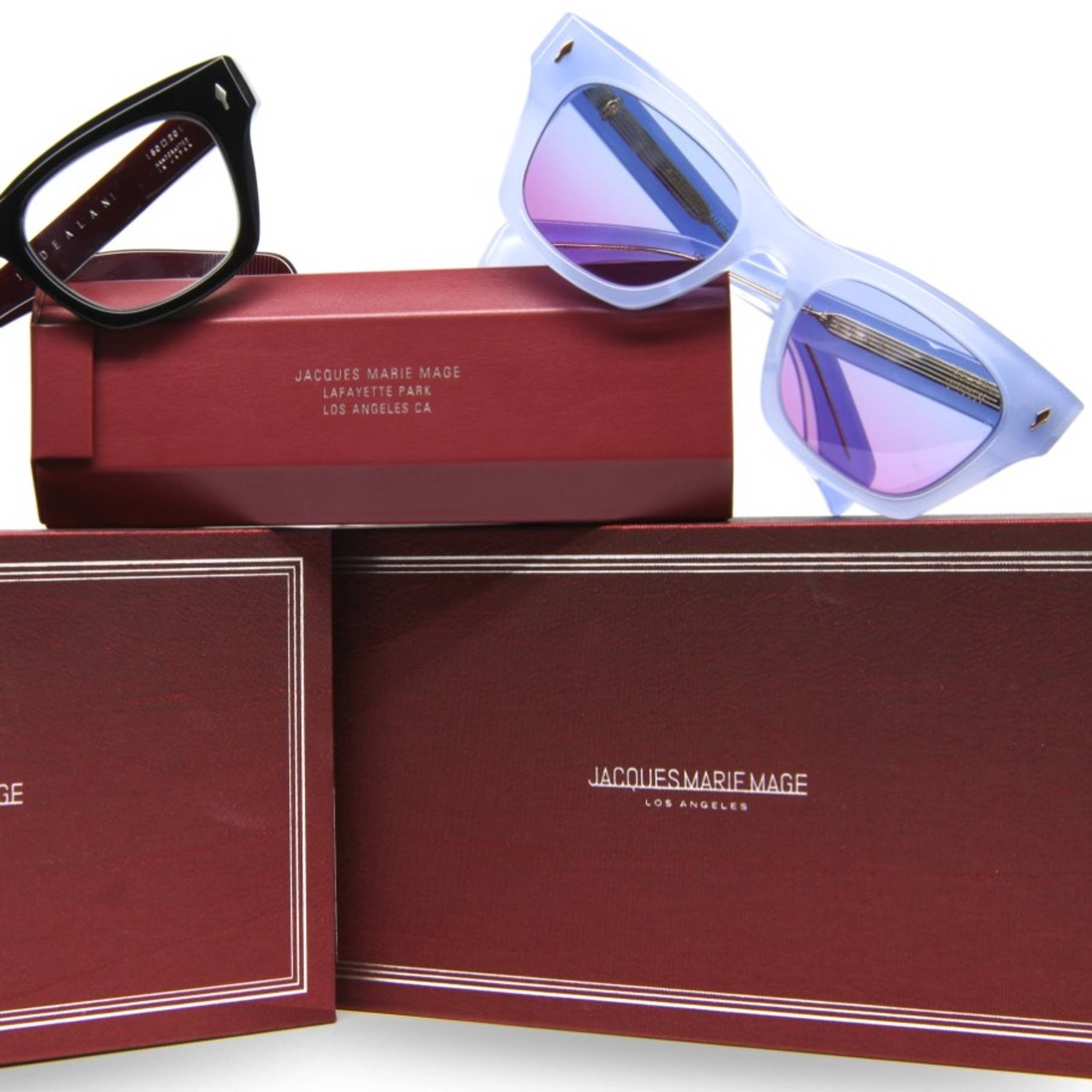 Two Jacques Marie Mage eyeglasses on collectors' cases.