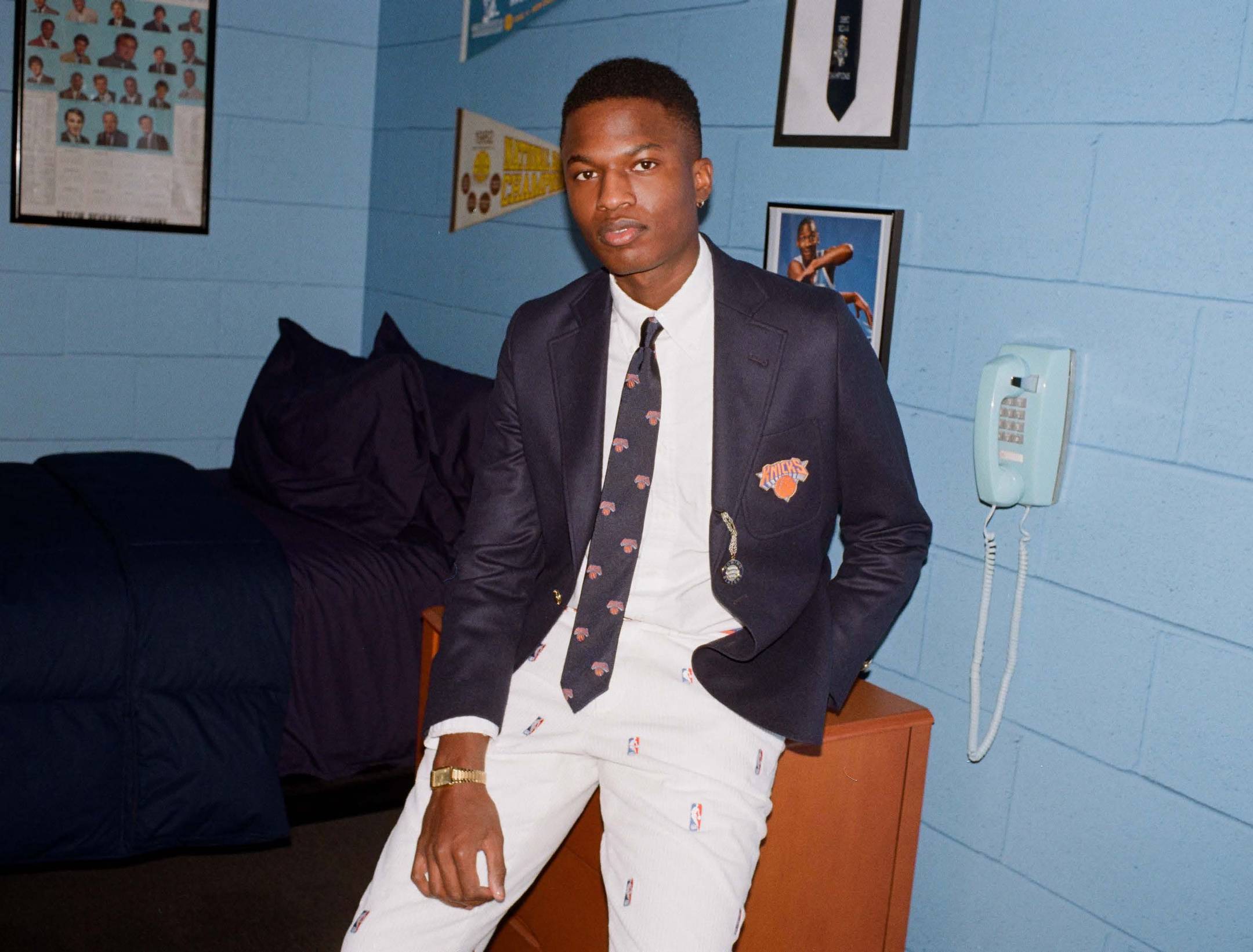 Model wearing the New York Knicks Tie and Blazer in a dorm room at The Graduate Chapel Hill.