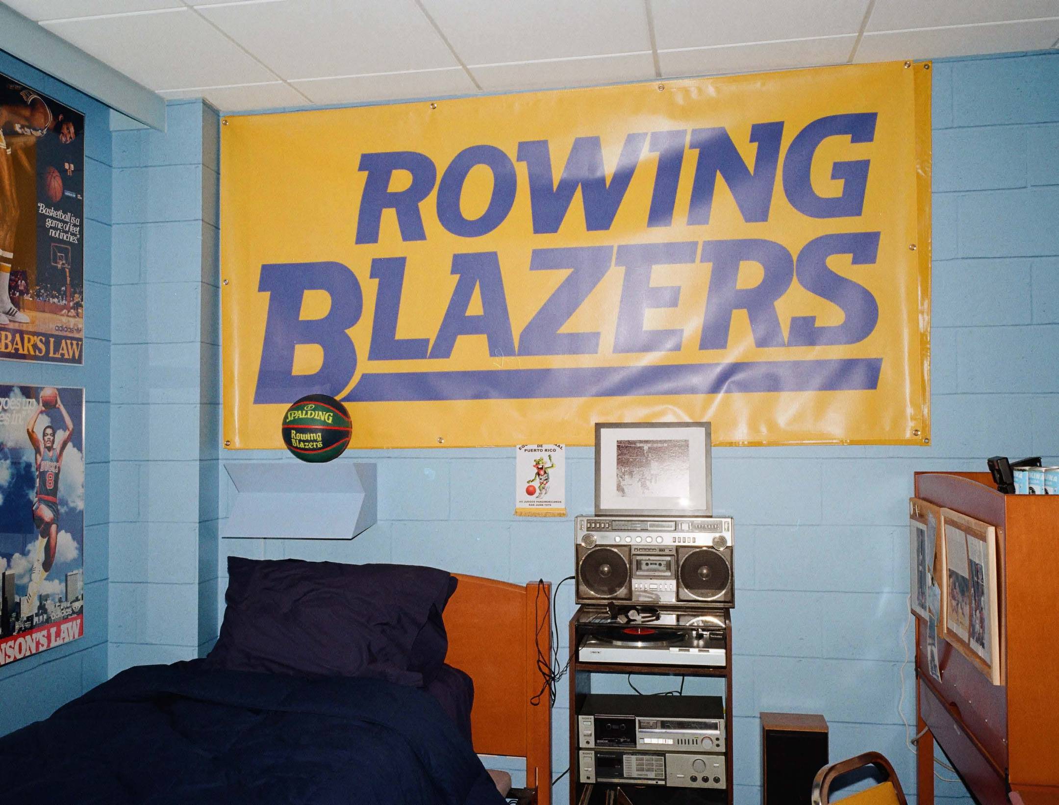 A recreation of one of Rowing Blazers' favorite player's freshman dorm room located at The Graduate Chapel Hill. Pictured is a large Rowing Blazers banner and the Limited Edition Spalding Basketball.