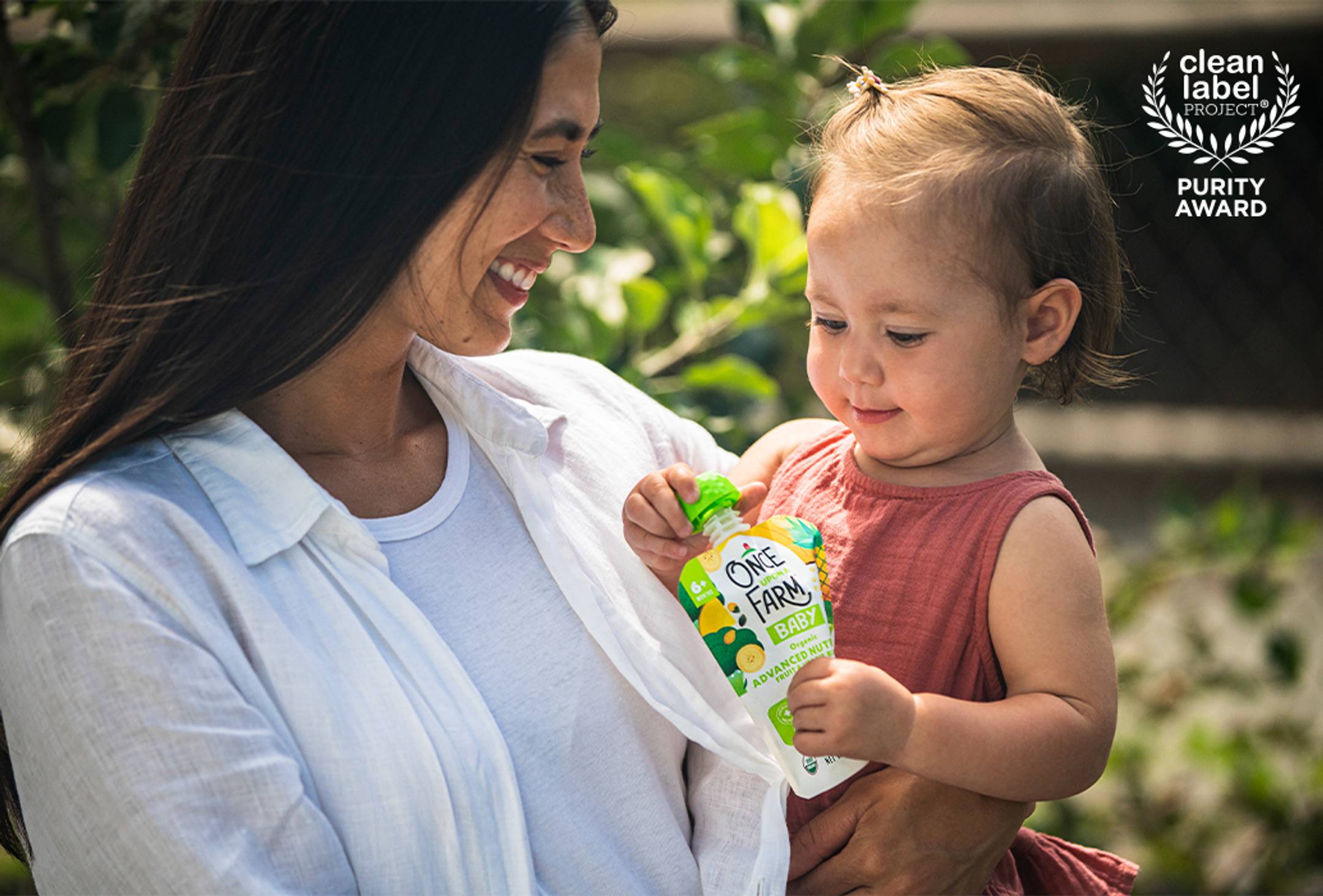 mom and baby enjoying a once upon a farm clean label project verified pouch