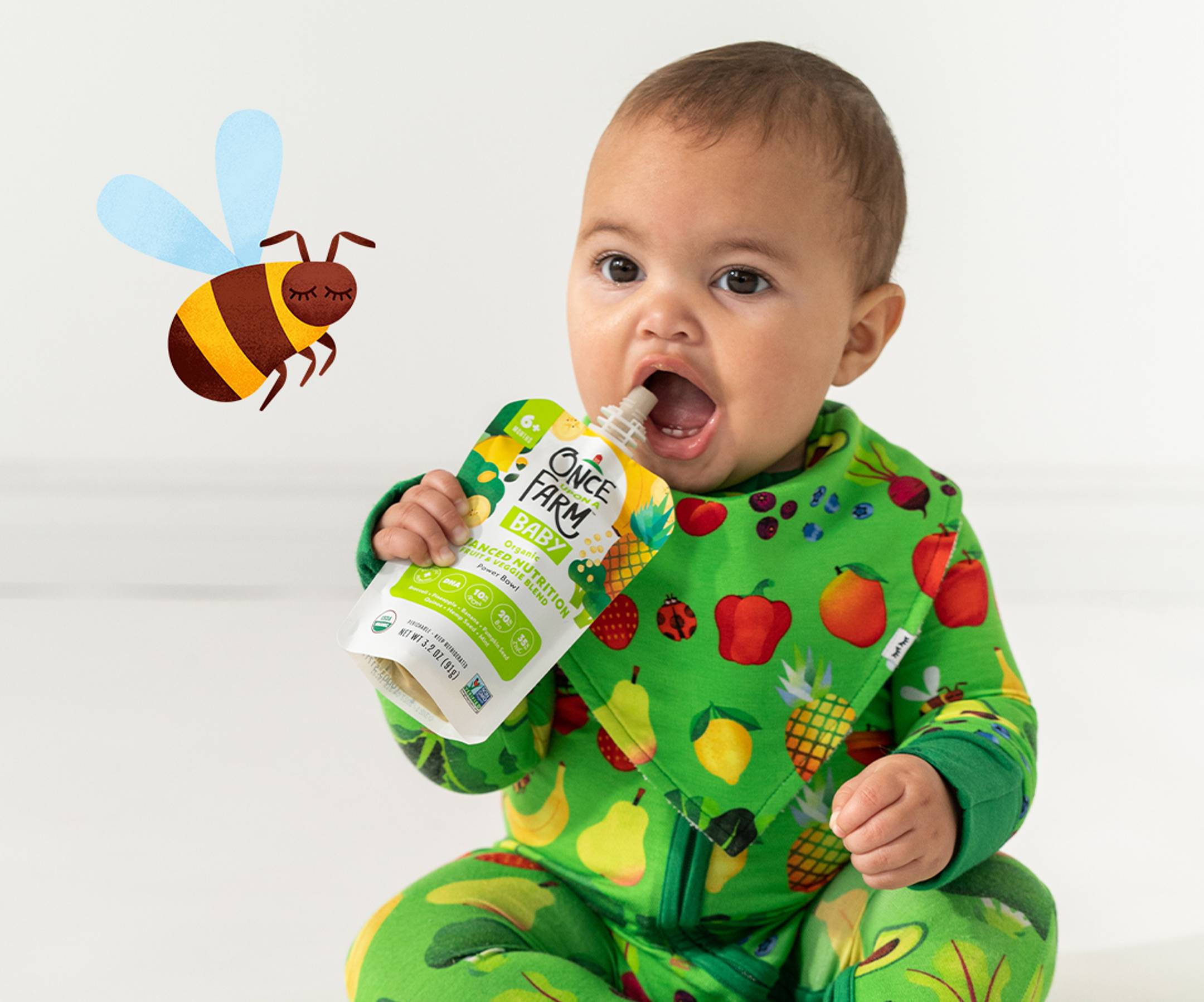 A baby in Little Sleepies x Once Upon a Farm pajamas eating an Advanced Nutrition Pouch with a sleepy bee illustration in the background. 