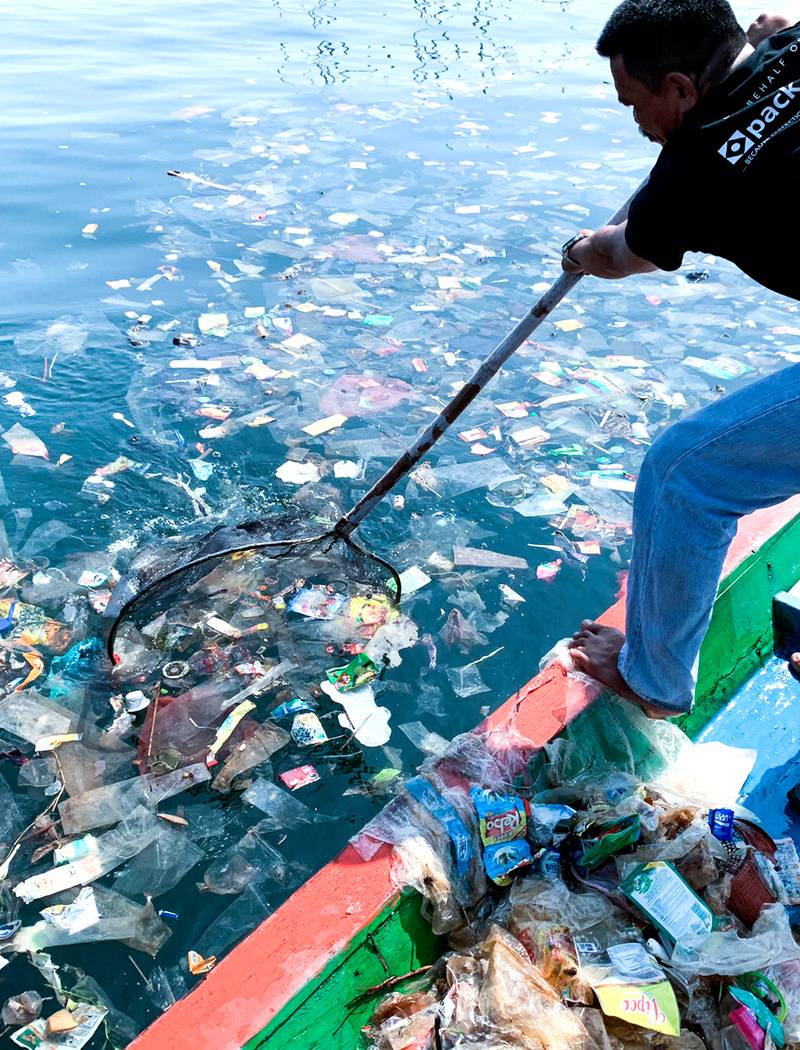 Indonesian fisherman collecting plastic waste from ocean | Kinship